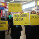 People hold welcome signs as they wait for Liu Xia, widow of Chinese Nobel Peace Prize-winning political dissident Liu Xiaobo, at Tegel airport in Berlin, Germany, July 10, 2018.